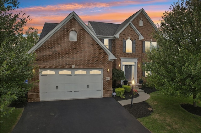 view of front facade featuring a garage and a lawn