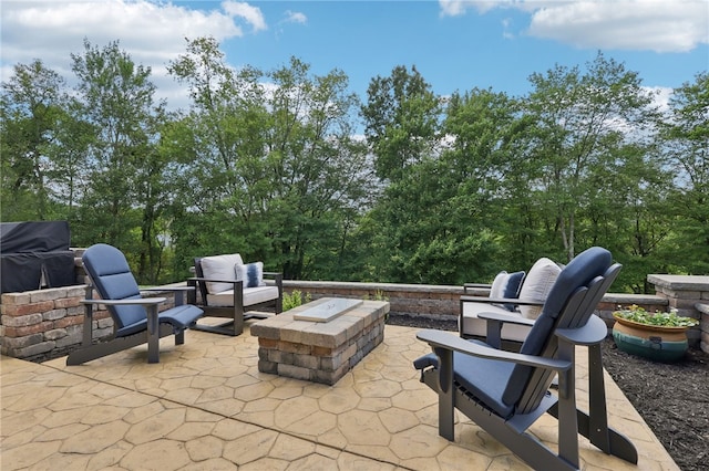 view of patio / terrace featuring an outdoor fire pit and grilling area