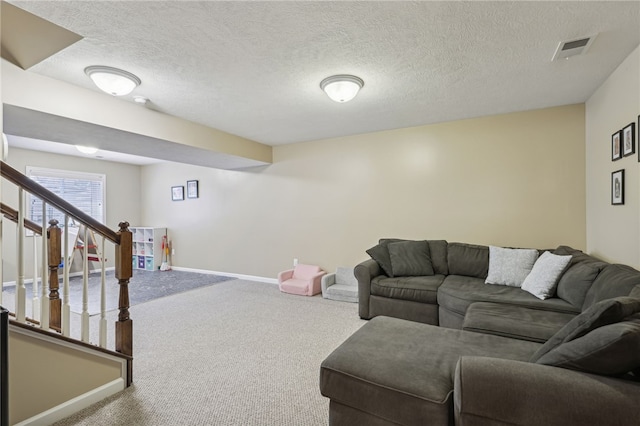 carpeted living room with a textured ceiling