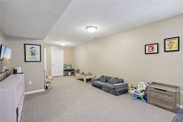 playroom with carpet and a textured ceiling