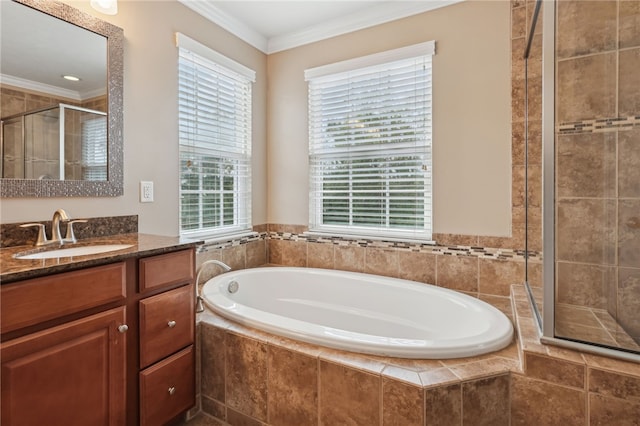 bathroom with vanity, ornamental molding, and separate shower and tub