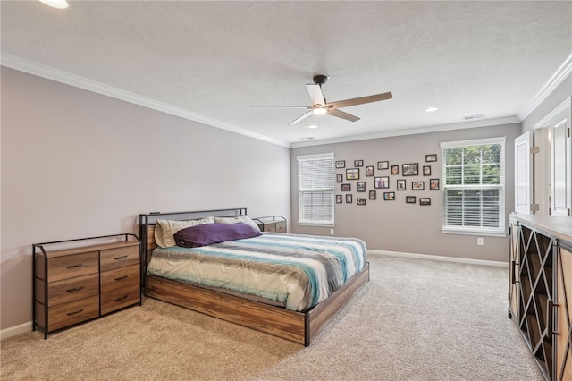 bedroom featuring crown molding, light carpet, a textured ceiling, and ceiling fan