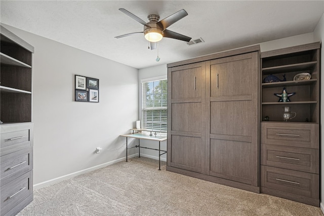 unfurnished bedroom with light colored carpet and ceiling fan