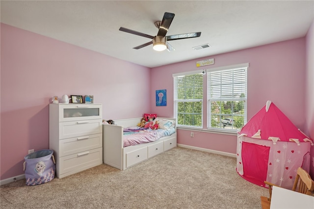 bedroom with ceiling fan and light carpet