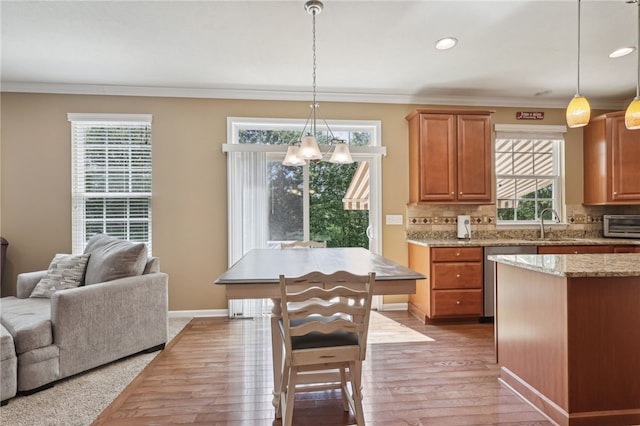 kitchen with backsplash, decorative light fixtures, and a wealth of natural light