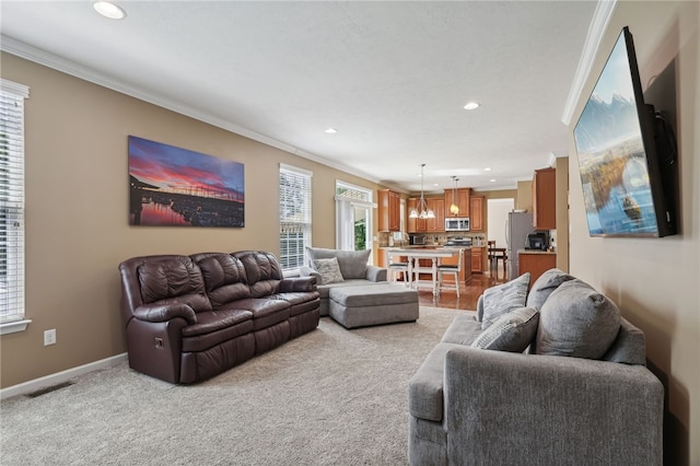 living room featuring ornamental molding and light colored carpet