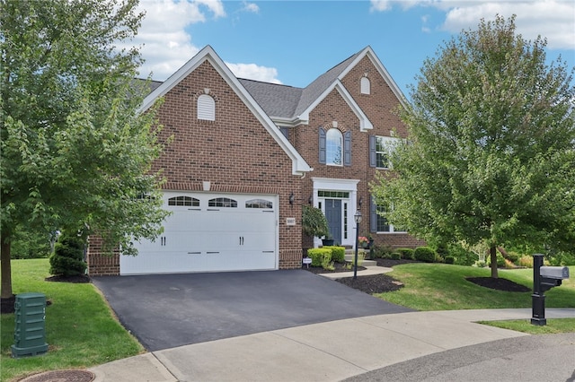 view of front of home featuring a front yard and a garage