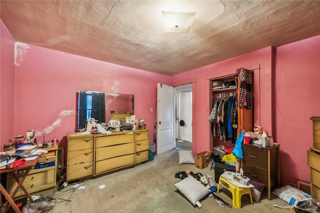 bedroom with light carpet, a closet, and a textured ceiling