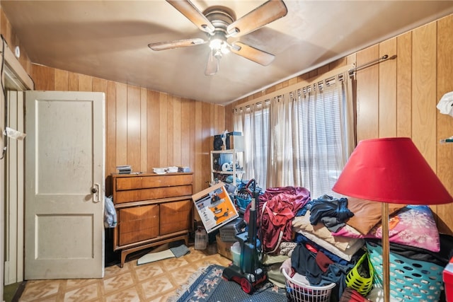 miscellaneous room with lofted ceiling, ceiling fan, and wood walls