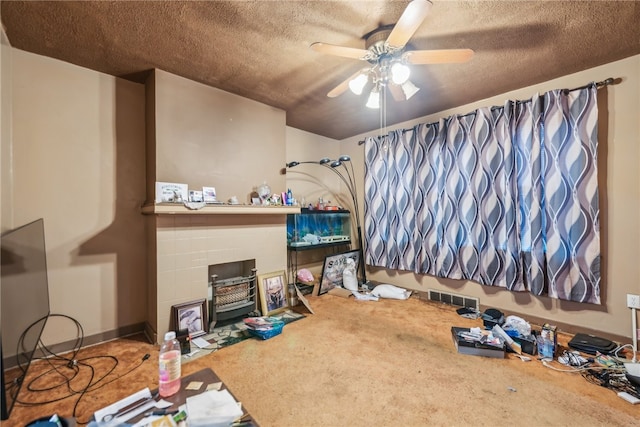 bedroom featuring a textured ceiling, carpet floors, and ceiling fan