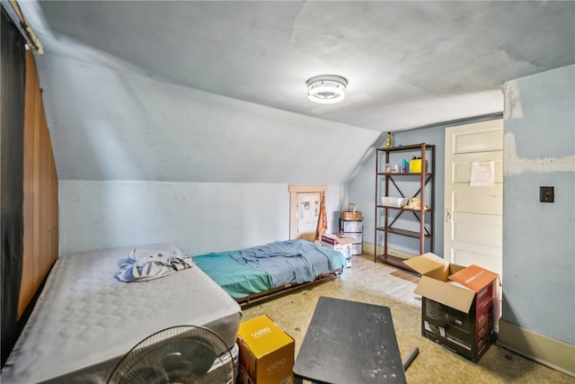 carpeted bedroom with lofted ceiling