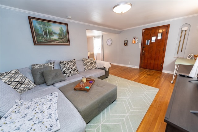 living room featuring crown molding and hardwood / wood-style flooring