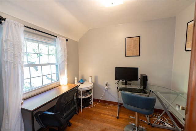 home office featuring lofted ceiling, hardwood / wood-style floors, and plenty of natural light