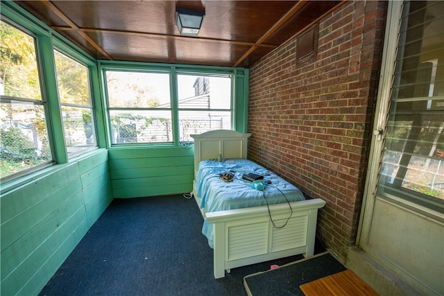 sunroom featuring a jacuzzi and a healthy amount of sunlight