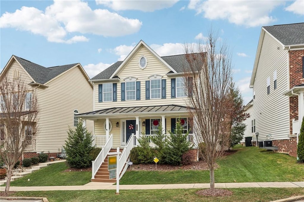 view of front of home featuring cooling unit, a front lawn, and a porch