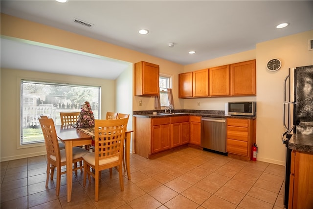 kitchen featuring light tile patterned floors, stainless steel appliances, and sink