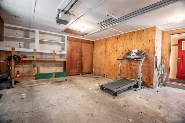 exercise area with wooden walls and concrete floors