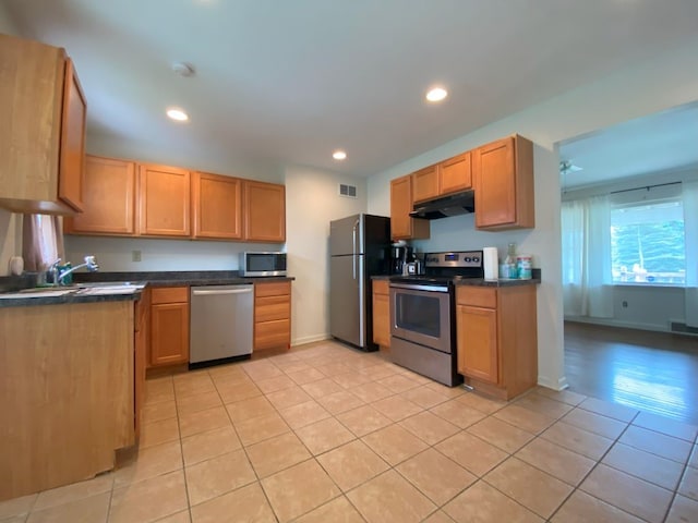 kitchen featuring sink, light tile patterned floors, and stainless steel appliances