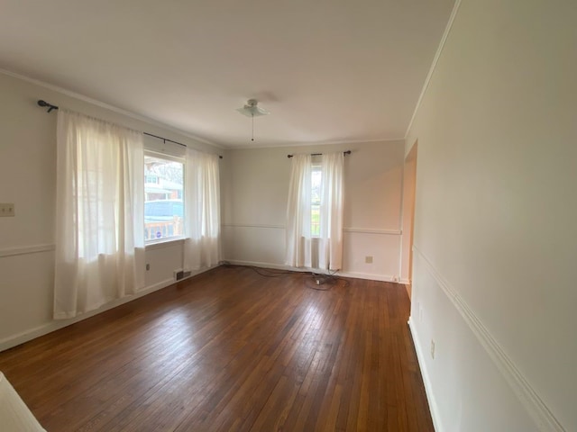 unfurnished room featuring dark hardwood / wood-style flooring and ornamental molding