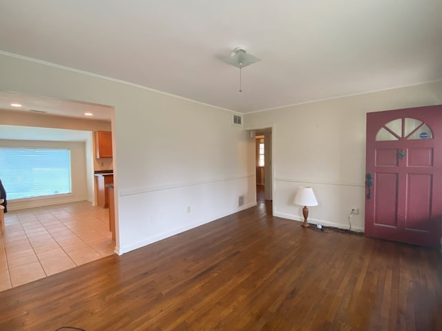 foyer entrance featuring hardwood / wood-style floors and ornamental molding