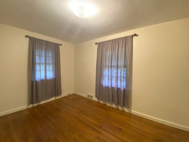 empty room with dark wood-type flooring