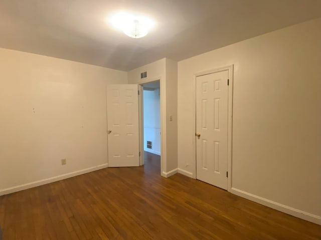 empty room featuring dark hardwood / wood-style flooring