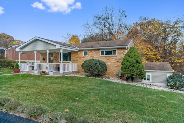 back of property featuring a porch and a lawn