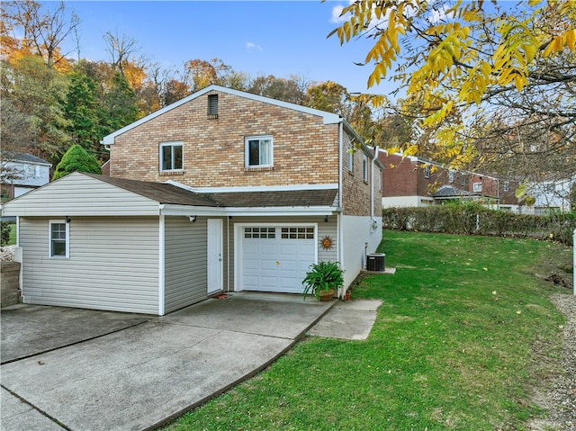 back of house featuring cooling unit, a garage, and a yard