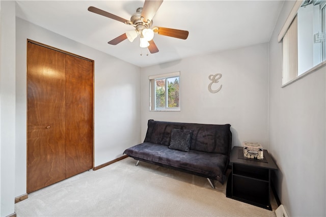 sitting room with light carpet and ceiling fan