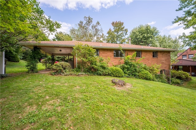 rear view of property featuring a lawn