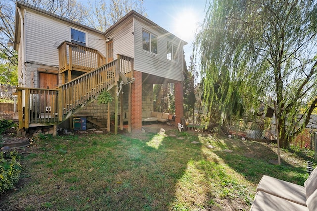 rear view of house with a yard and a deck