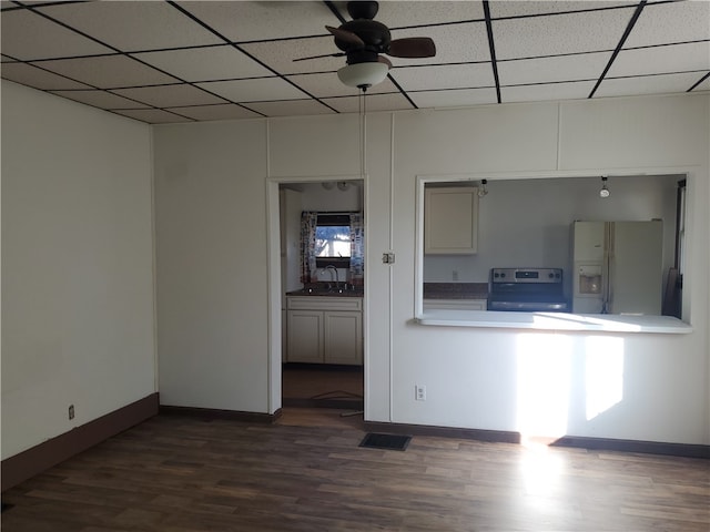 interior space with dark hardwood / wood-style flooring, ceiling fan, stainless steel range with electric cooktop, and white fridge with ice dispenser