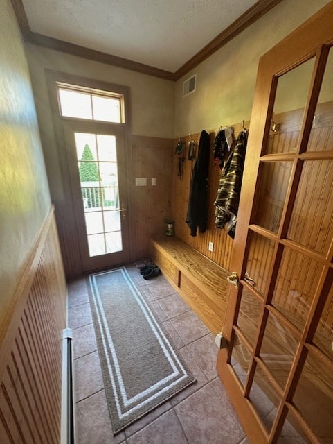 mudroom with tile patterned floors and crown molding