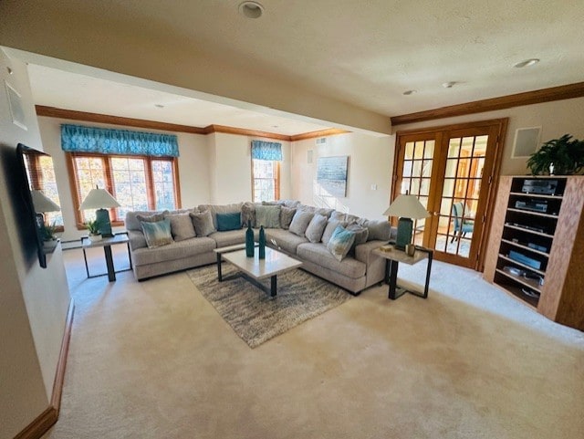 carpeted living room featuring french doors and ornamental molding