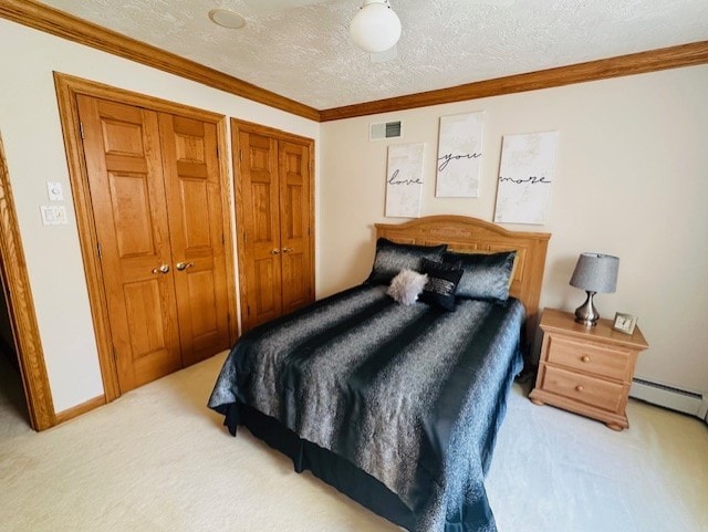 carpeted bedroom with a baseboard radiator, a textured ceiling, and ornamental molding