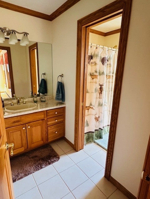 bathroom featuring tile patterned flooring, vanity, and crown molding