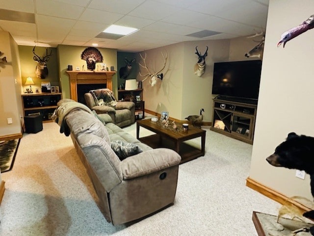 living room with carpet flooring and a drop ceiling