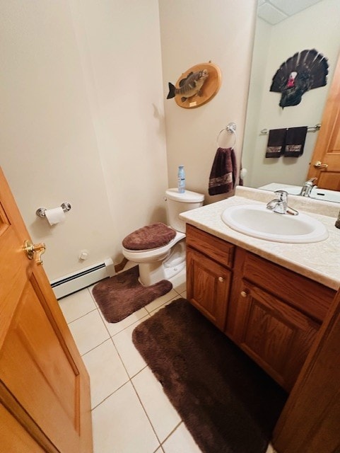 bathroom with tile patterned flooring, vanity, a baseboard radiator, and toilet