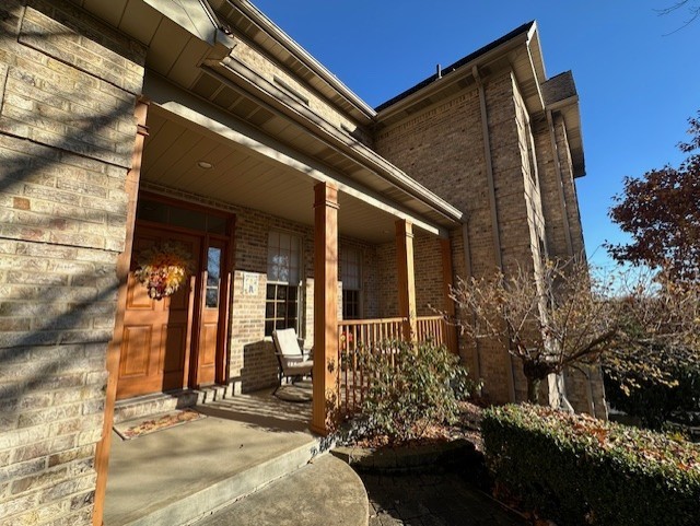 view of exterior entry with a porch