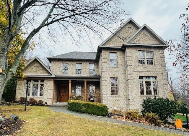 view of front of property with covered porch and a front yard