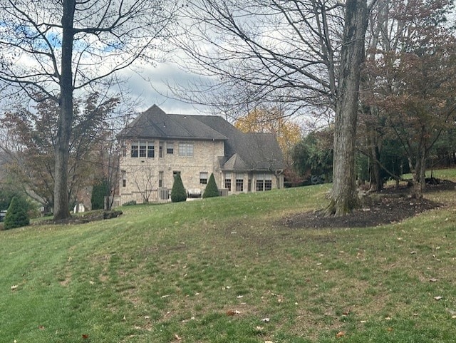 view of side of home featuring a lawn