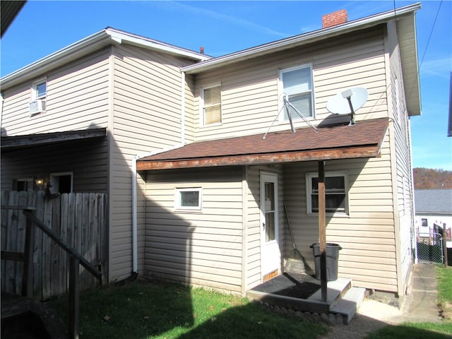 rear view of property featuring cooling unit