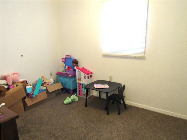 playroom featuring dark colored carpet