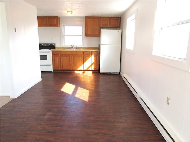 kitchen featuring baseboard heating, sink, dark wood-type flooring, and white appliances