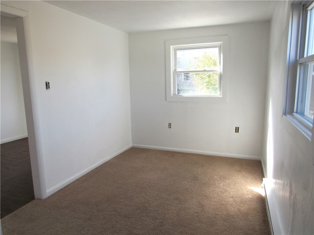 spare room with dark colored carpet