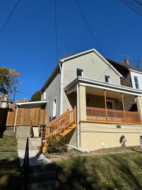 view of side of property featuring a porch