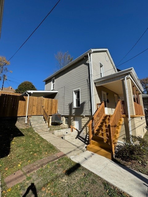 view of side of home featuring central air condition unit and a porch