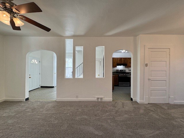 carpeted empty room with ceiling fan