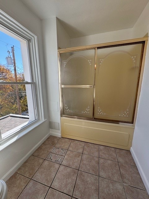 bathroom with enclosed tub / shower combo and tile patterned flooring