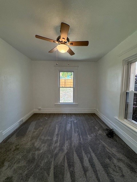 carpeted empty room with ceiling fan and a textured ceiling